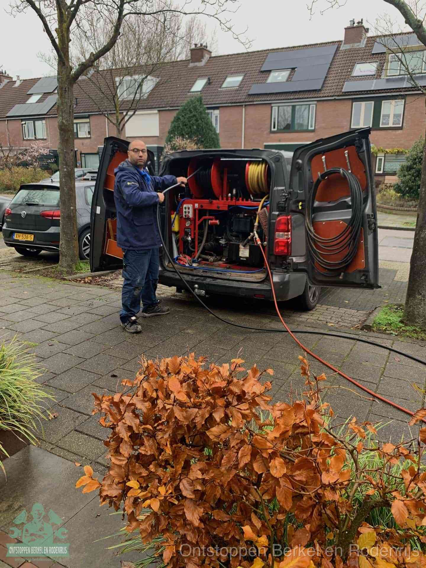 Monteur met rioolreinigingsbus levert rioolservice in de wijk in Berkel en Rodenrijs